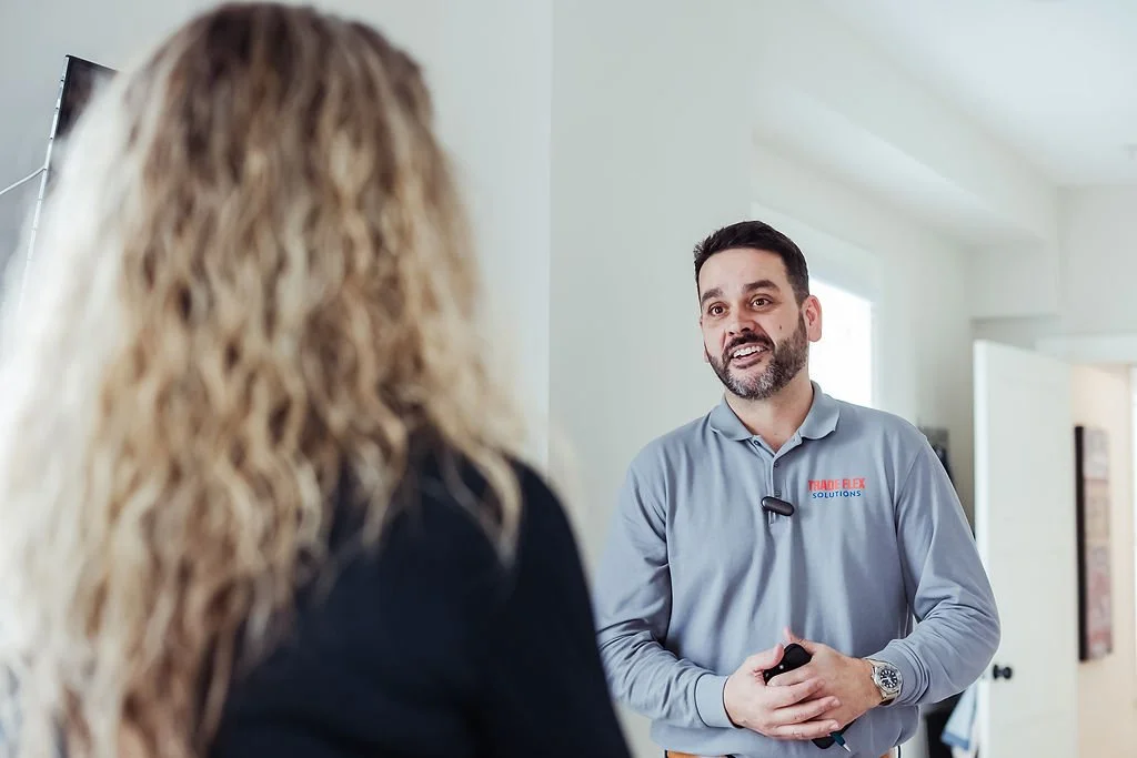 A Trade Flex Solutions technician speaking with a homeowner